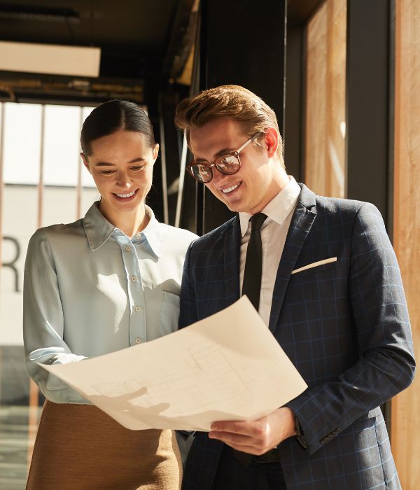 image of a real estate agent showing floorplan to client